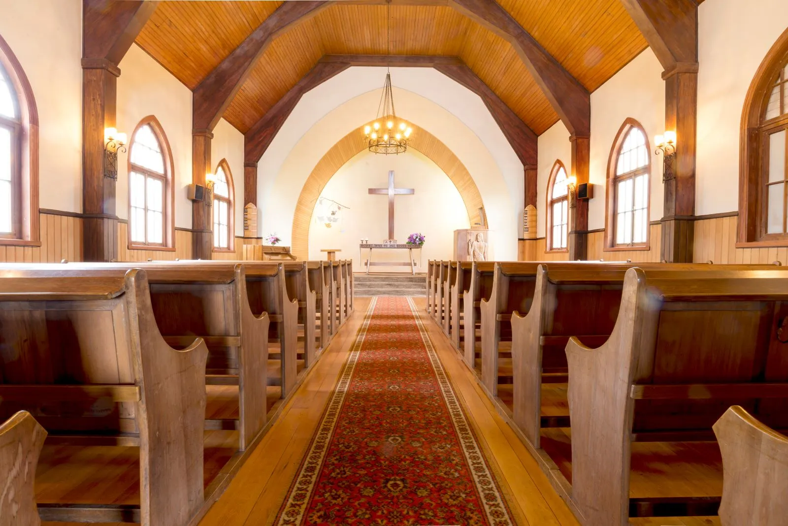 View of a welcoming church seen from the back pews.